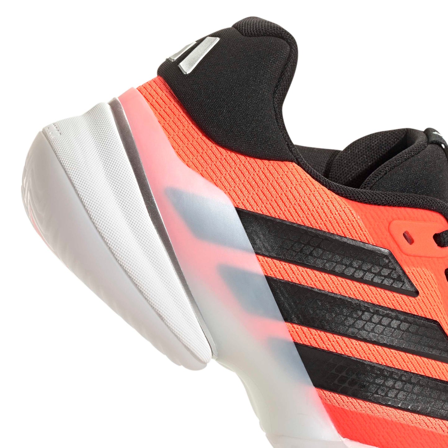 Close-up of an orange and black Adidas tennis shoe with a white sole on a white background