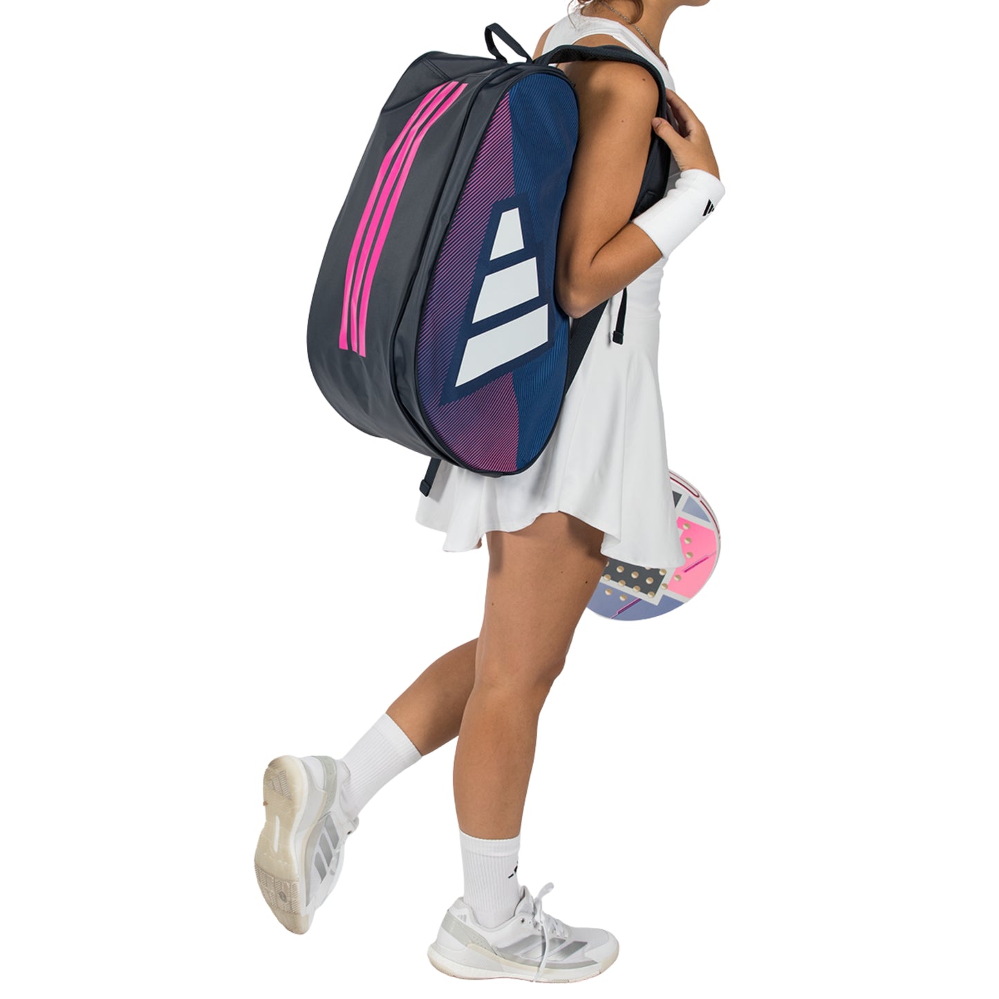 Person holding a blue and pink Adidas tennis bag with a white background