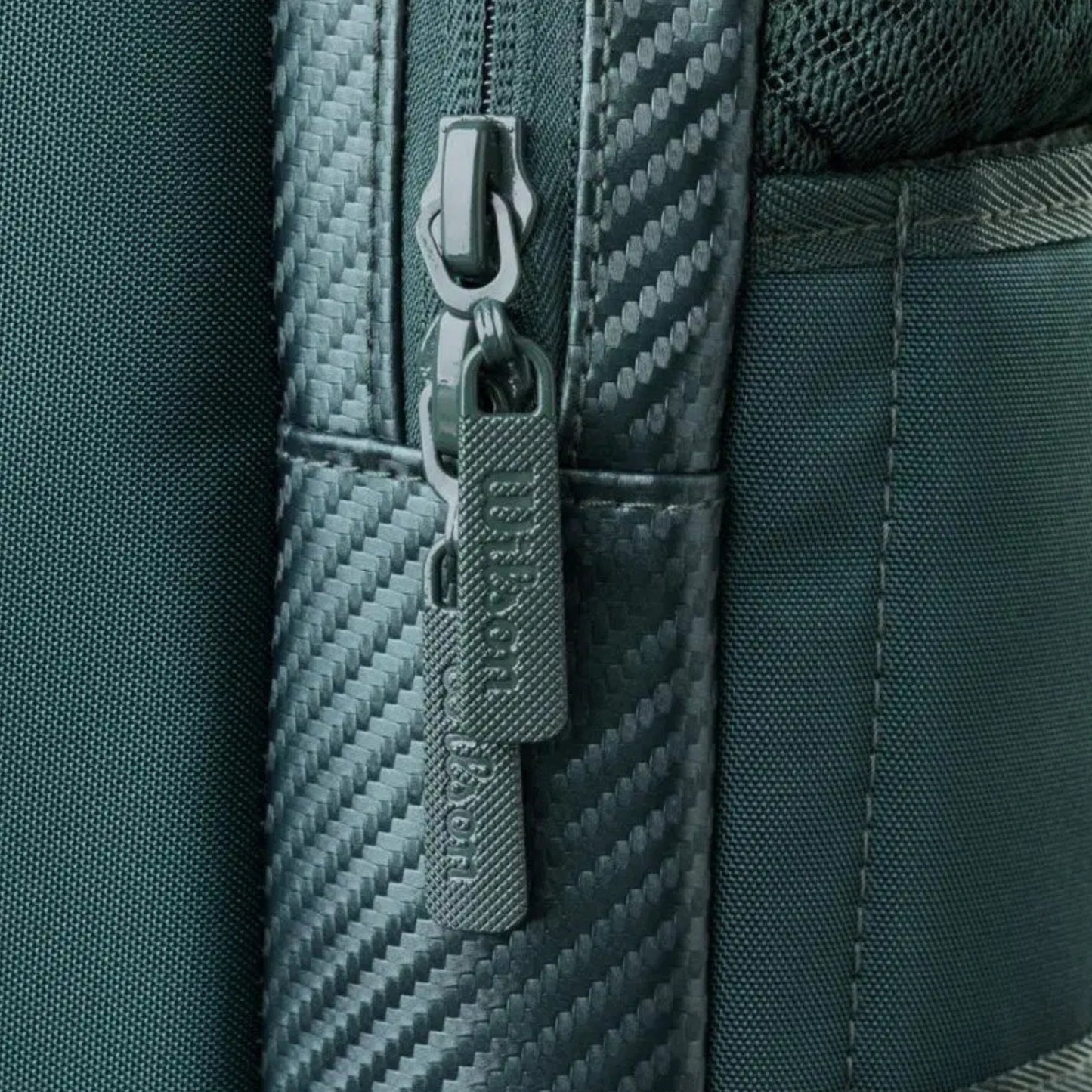 Close-up of a zipper on a textured green bag