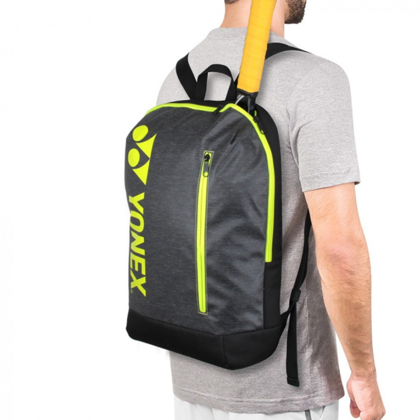 Person wearing a Yonex backpack with a gray and yellow design on a white background