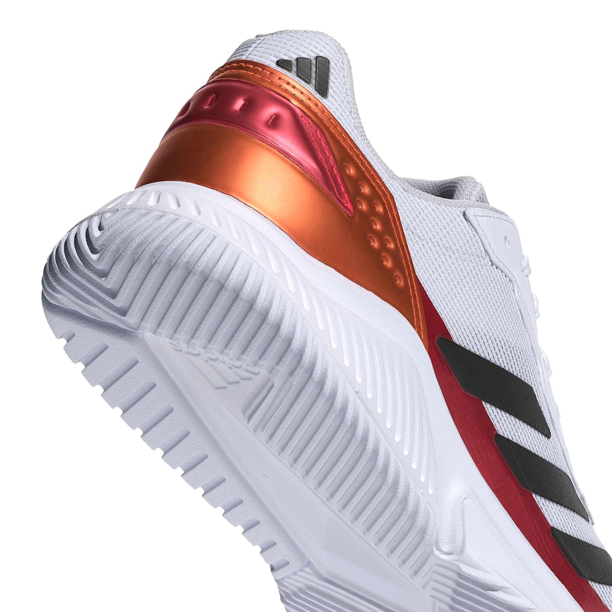White padel shoe with orange and red accents on a white background