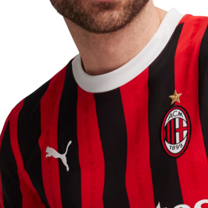 Close-up of a red and black striped Puma sports jersey with a logo on a white background