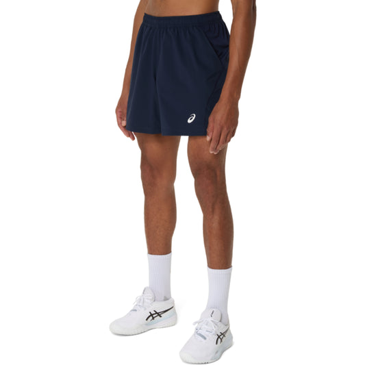 Person wearing navy athletic Asics shorts with a brand logo on a white background
