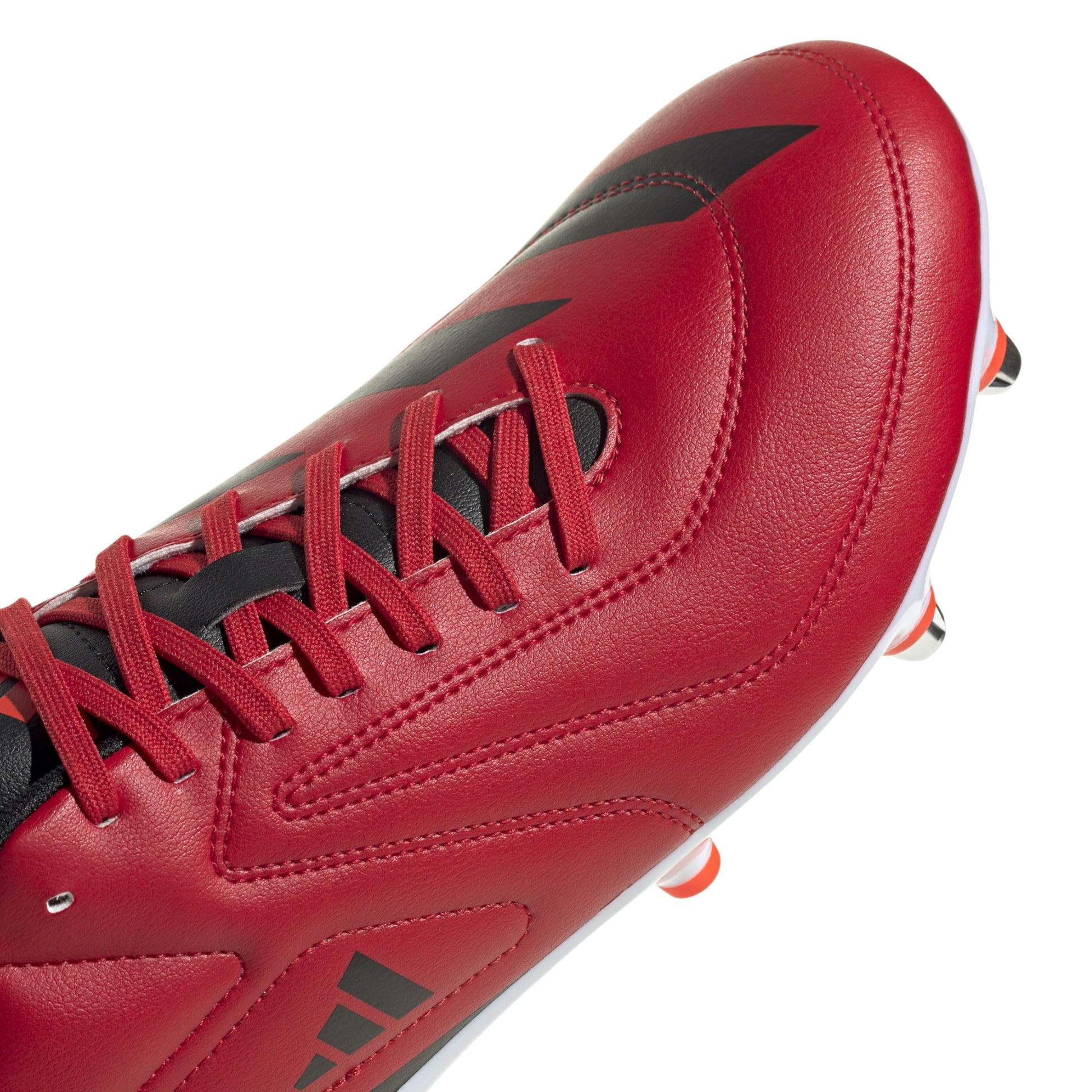 Red and black rugby boot with white sole on a white background