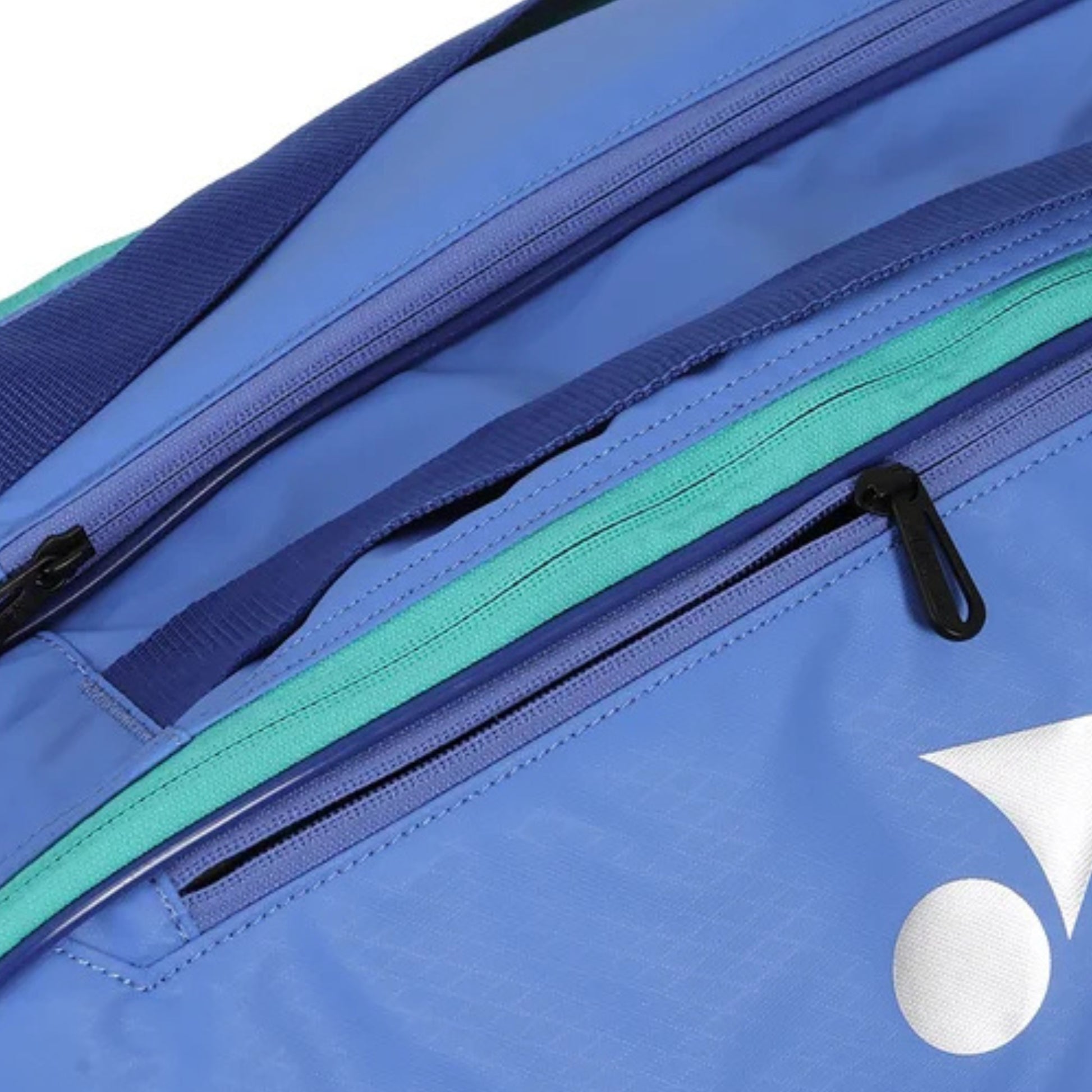 Close-up of a blue tennis bag with a visible brand logo on a white background
