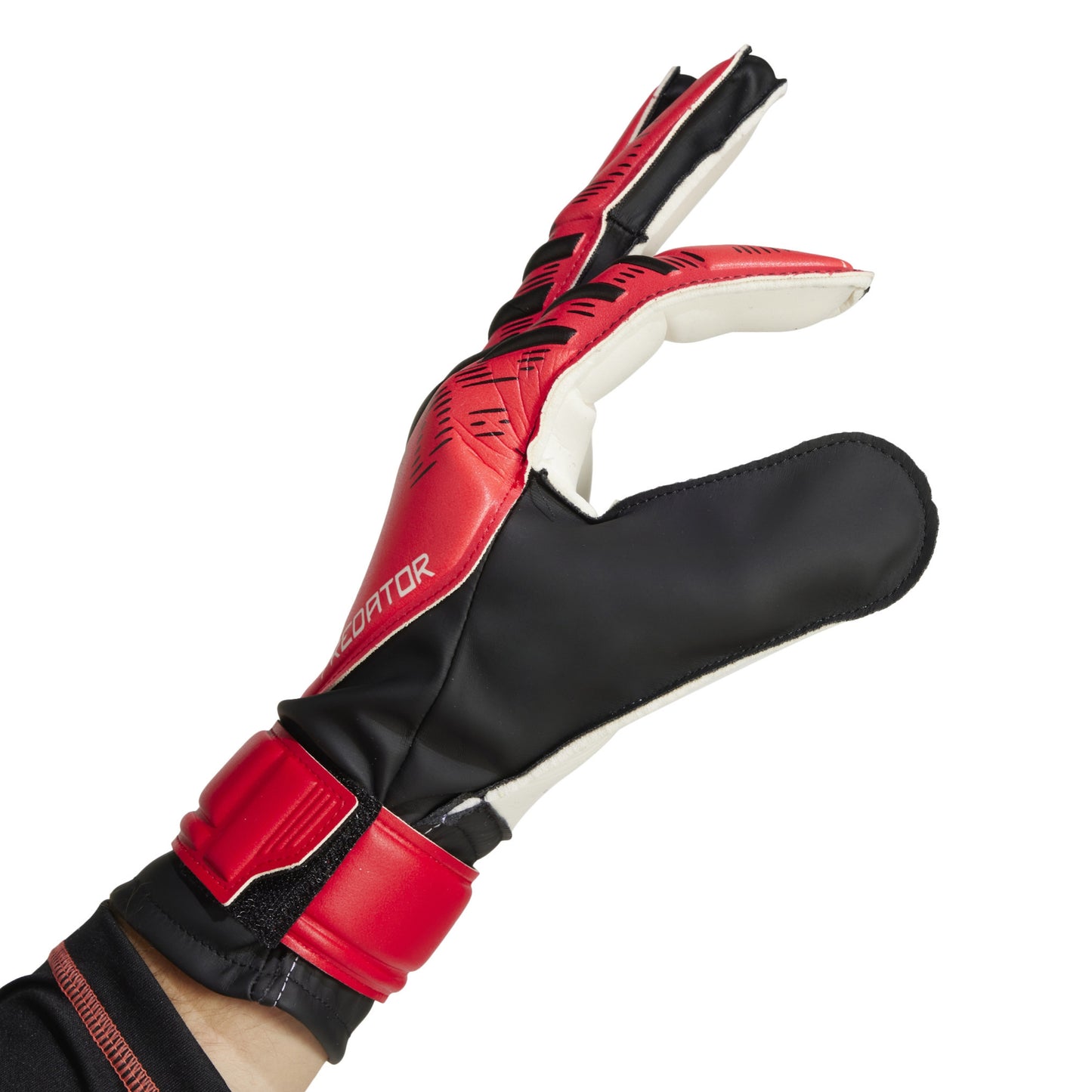 Red and black Adidas soccer goalkeeper glove on a white background
