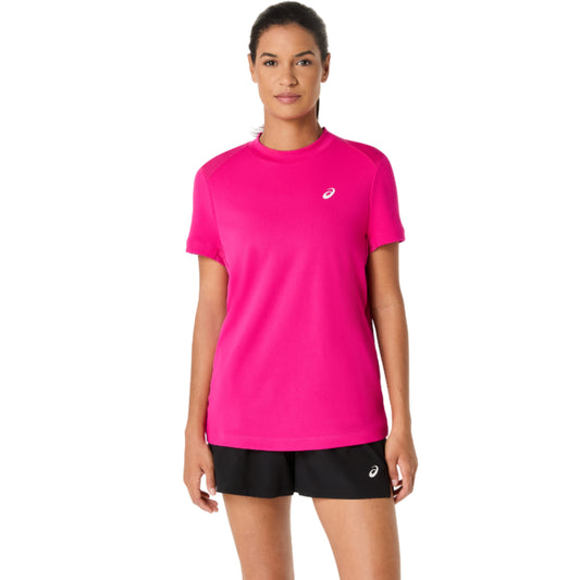 Woman wearing a bright pink Asics athletic shirt and black shorts with a visible brand logo on a white background