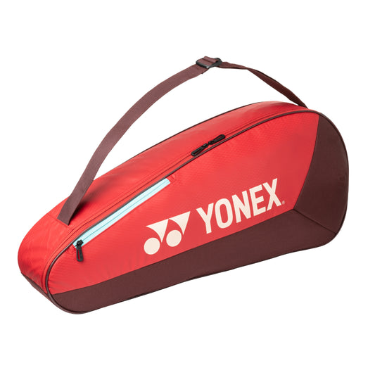 Red Yonex tennis bag with brown accents on a white background