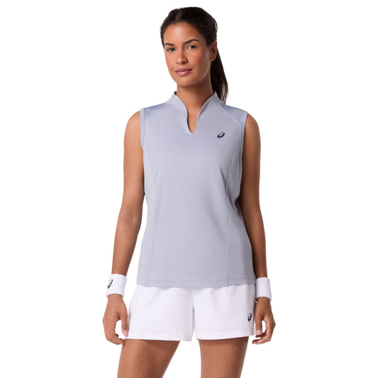 Woman wearing a light gray sleeveless Asics top and white shorts with a visible brand logo on a white background