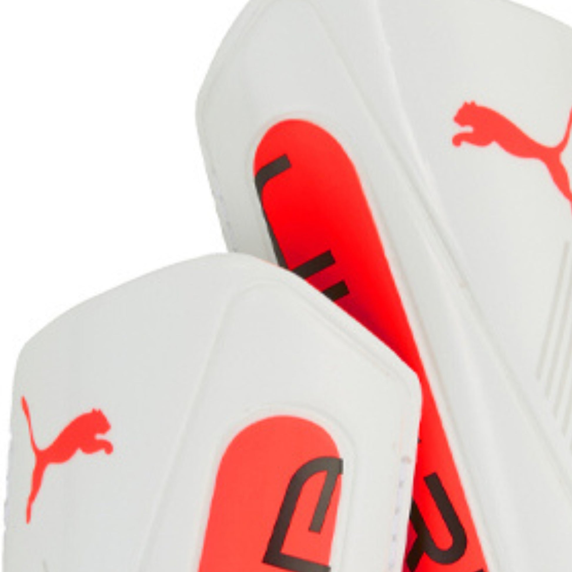 White sports outfit with red and black Puma logos on a white background