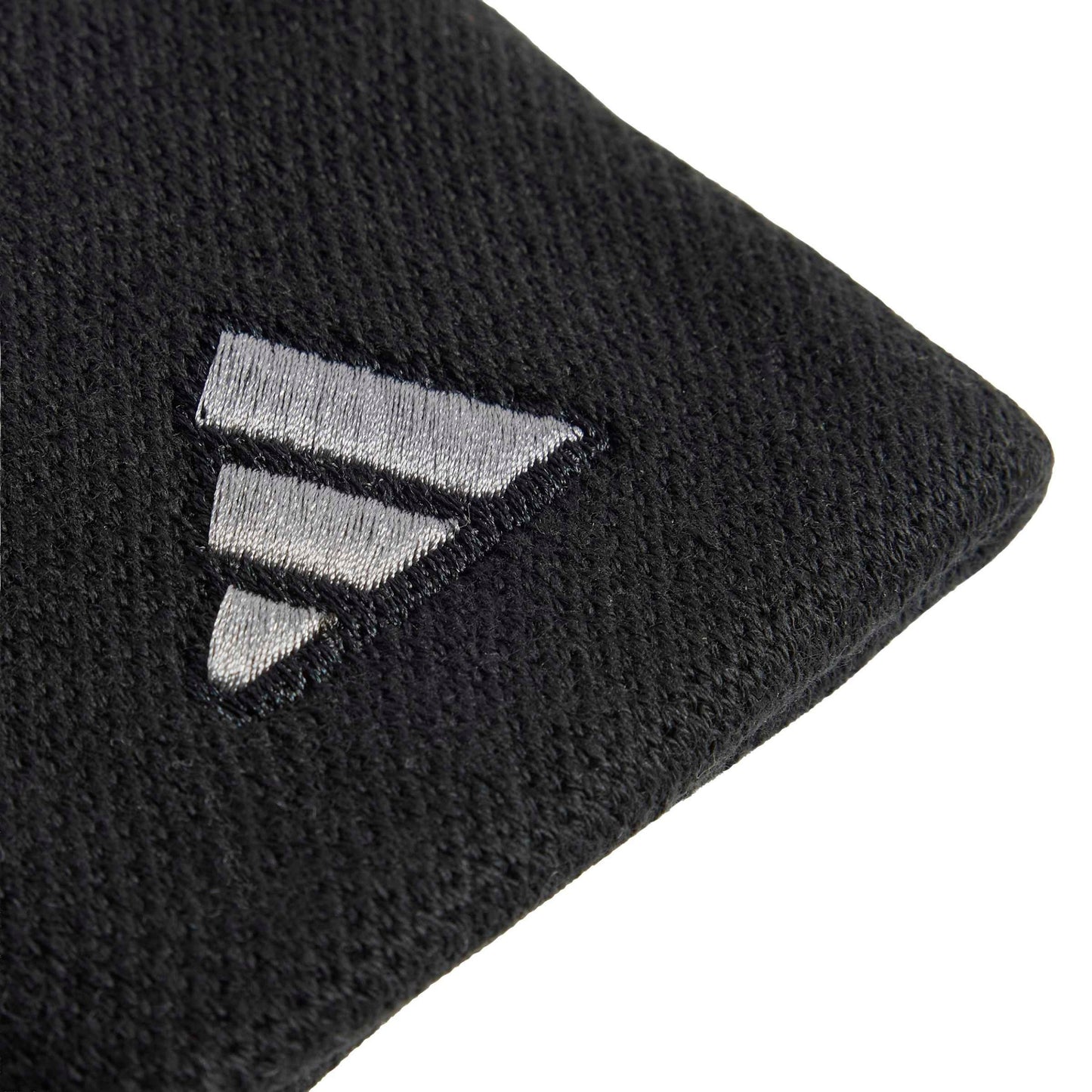 Close-up of a black textured wristband with a silver embroidered geometric logo on a white background.