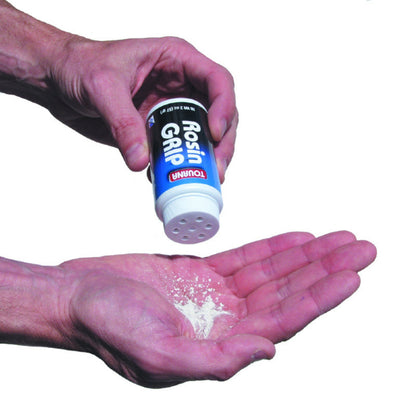 Hand holding a container of Rosin Grip powder above an open palm on a white background
