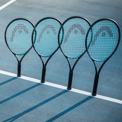 Four tennis rackets with blue strings on a tennis court