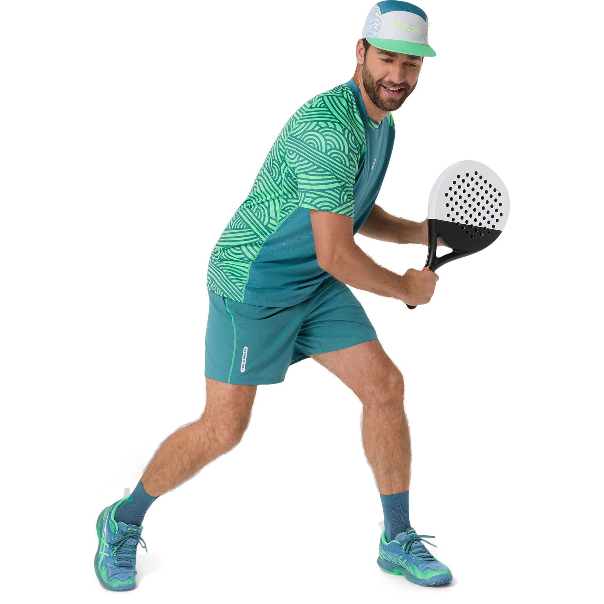 Man playing padel in green and blue athletic wear on a white background