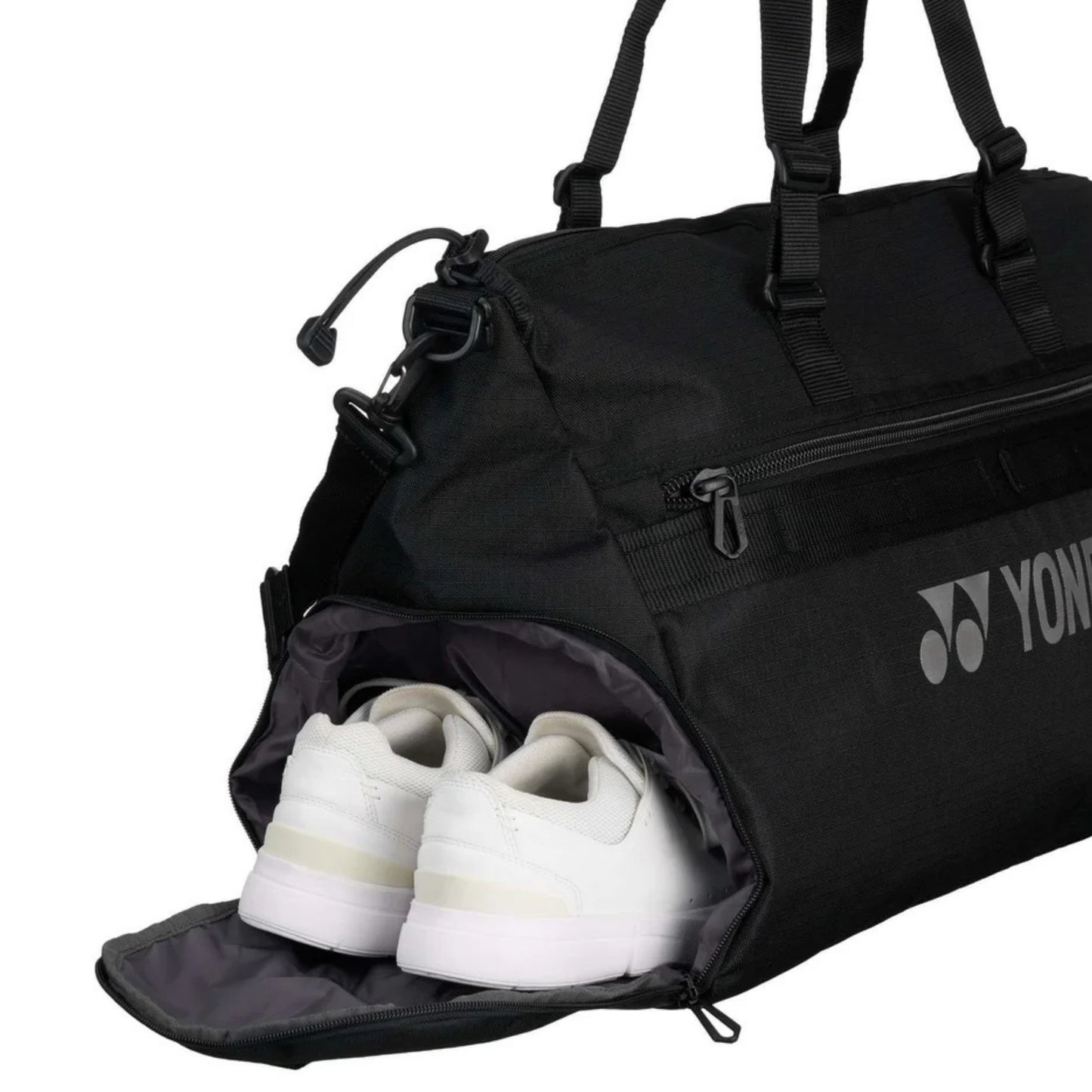 Black Yonex bag with white shoes inside, featuring Yonex logo.