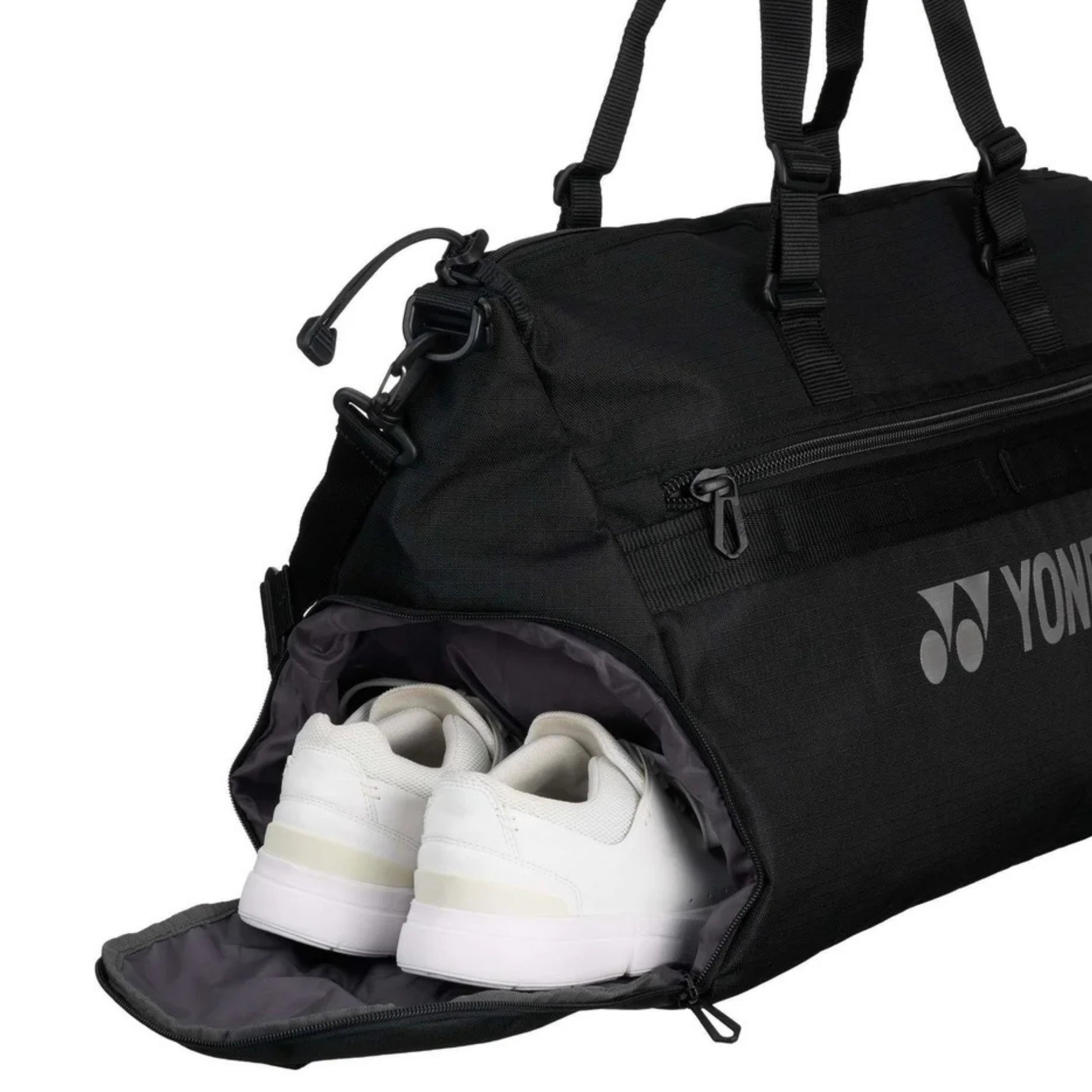 Black Yonex bag with white shoes inside, featuring Yonex logo.