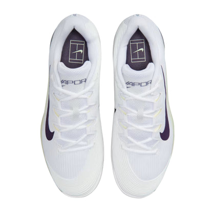 White tennis shoes with navy accents on a white background