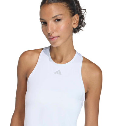 Woman wearing a white adidas dress top on a white background