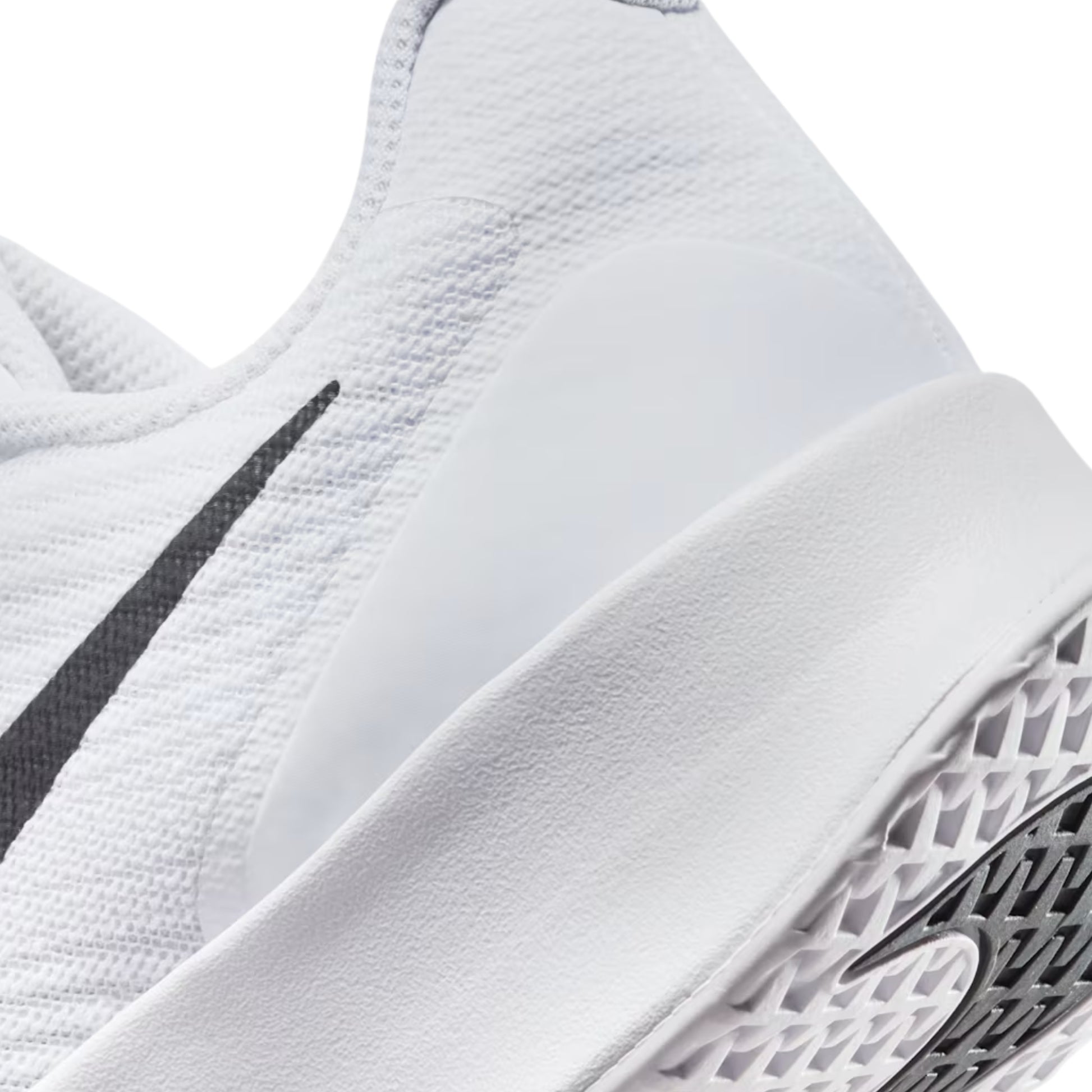 Close-up of a white tennis shoe with a black swoosh logo on a white background