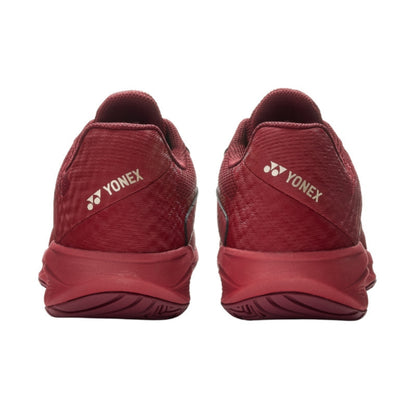 Red Yonex tennis shoes shown from the back on a white background