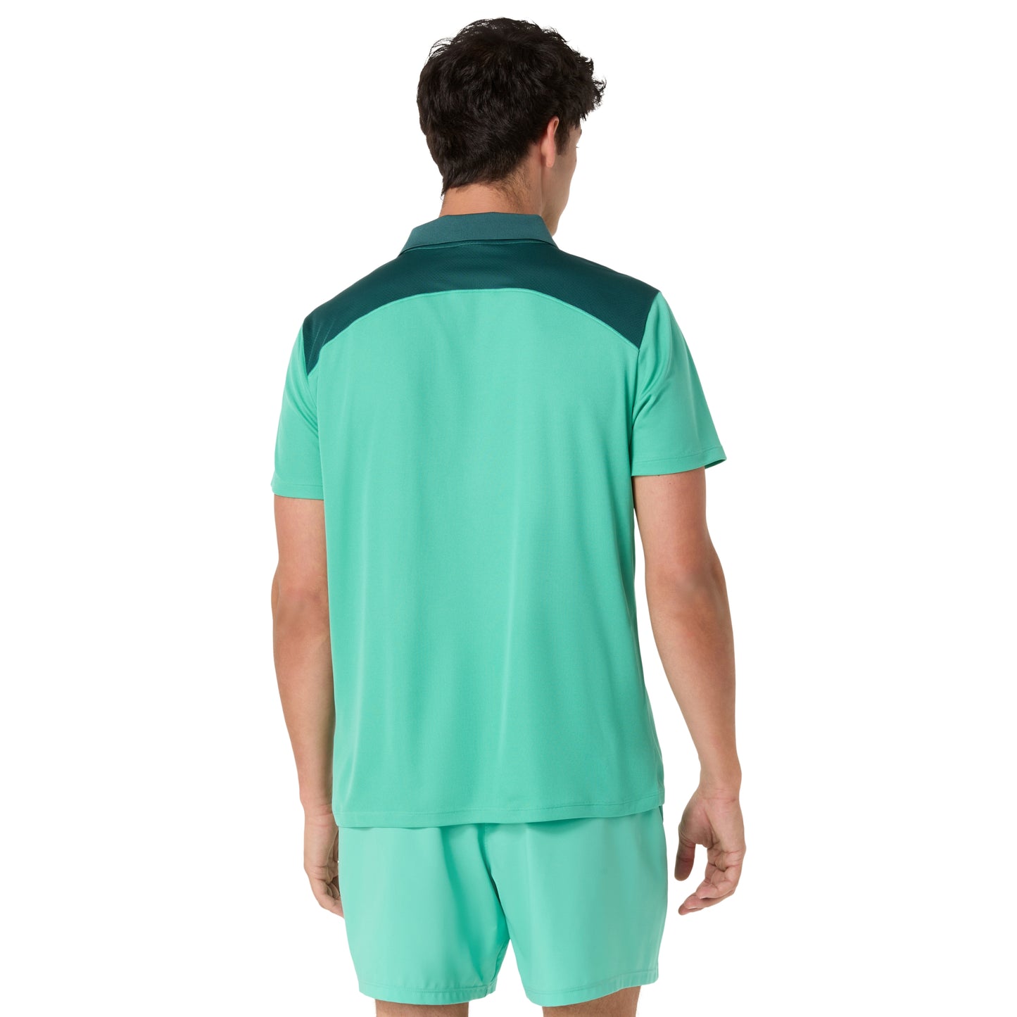 Person wearing a green and navy sports outfit on a white background