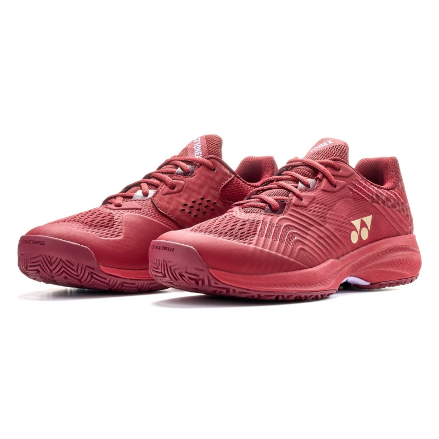 Red Yonex tennis shoes with a brand logo on a white background