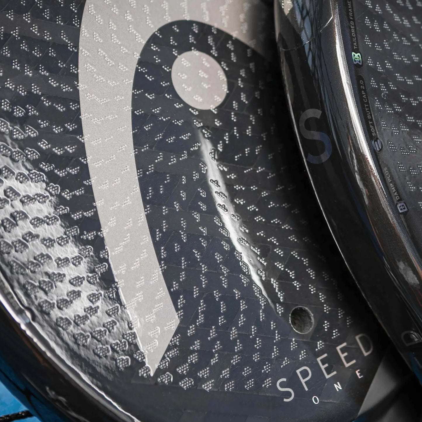 Close-up of a Head padel racket with the logo at the bottom on a white background