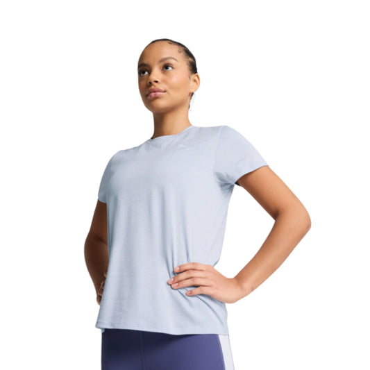Woman wearing a light blue Puma t-shirt on a white background