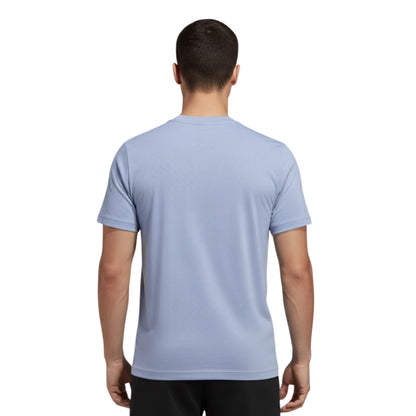 Man wearing a light blue t-shirt on a white background