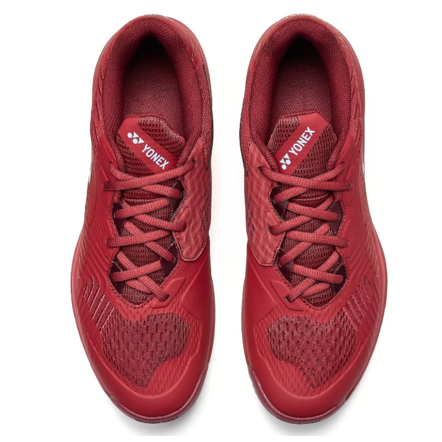 Red Yonex tennis shoes with Yonex logo on a white background