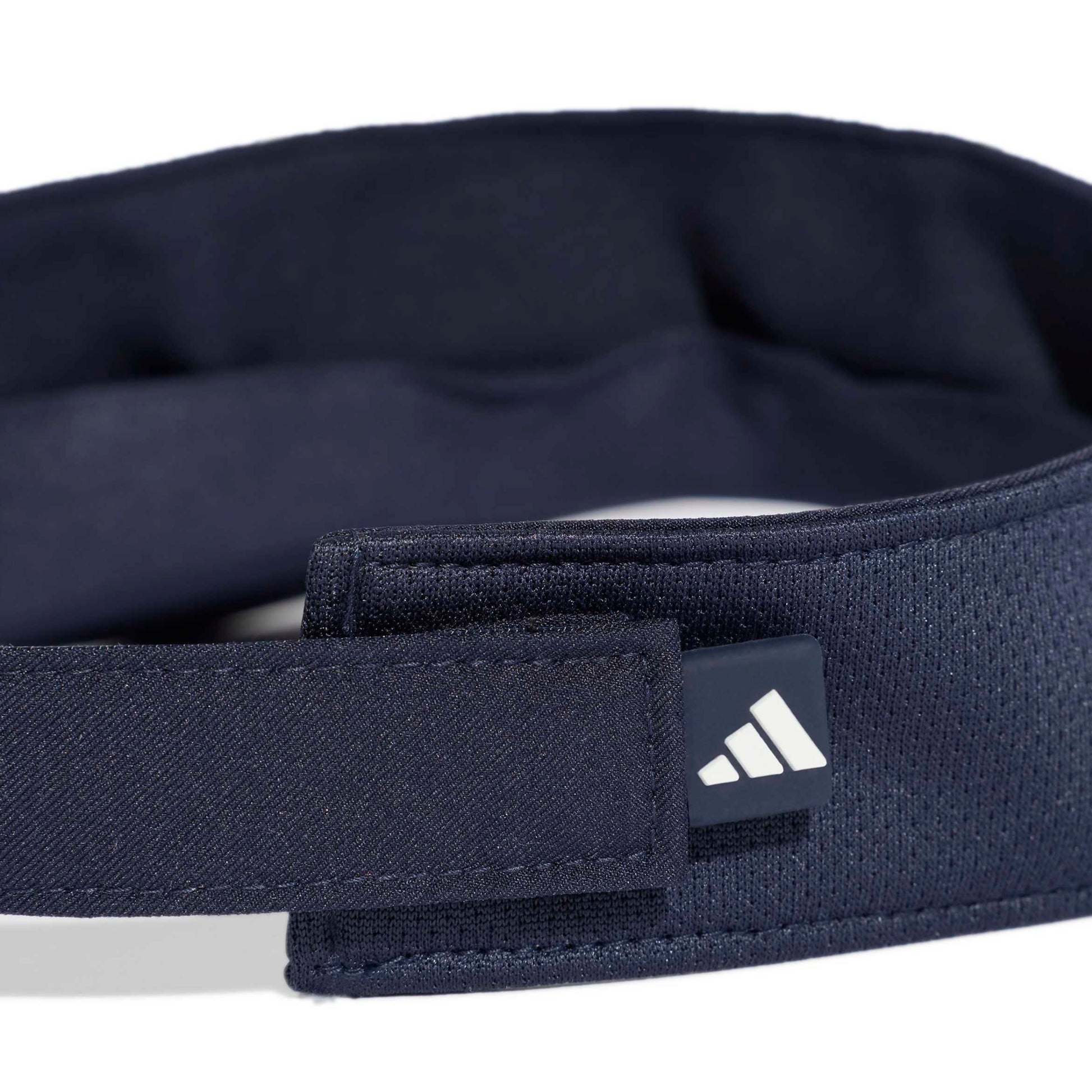 Back view of a navy blue visor with Adidas logo on a white background