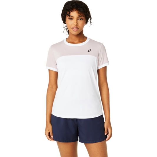 Woman wearing a two-tone Asics t-shirt and navy shorts on a white background
