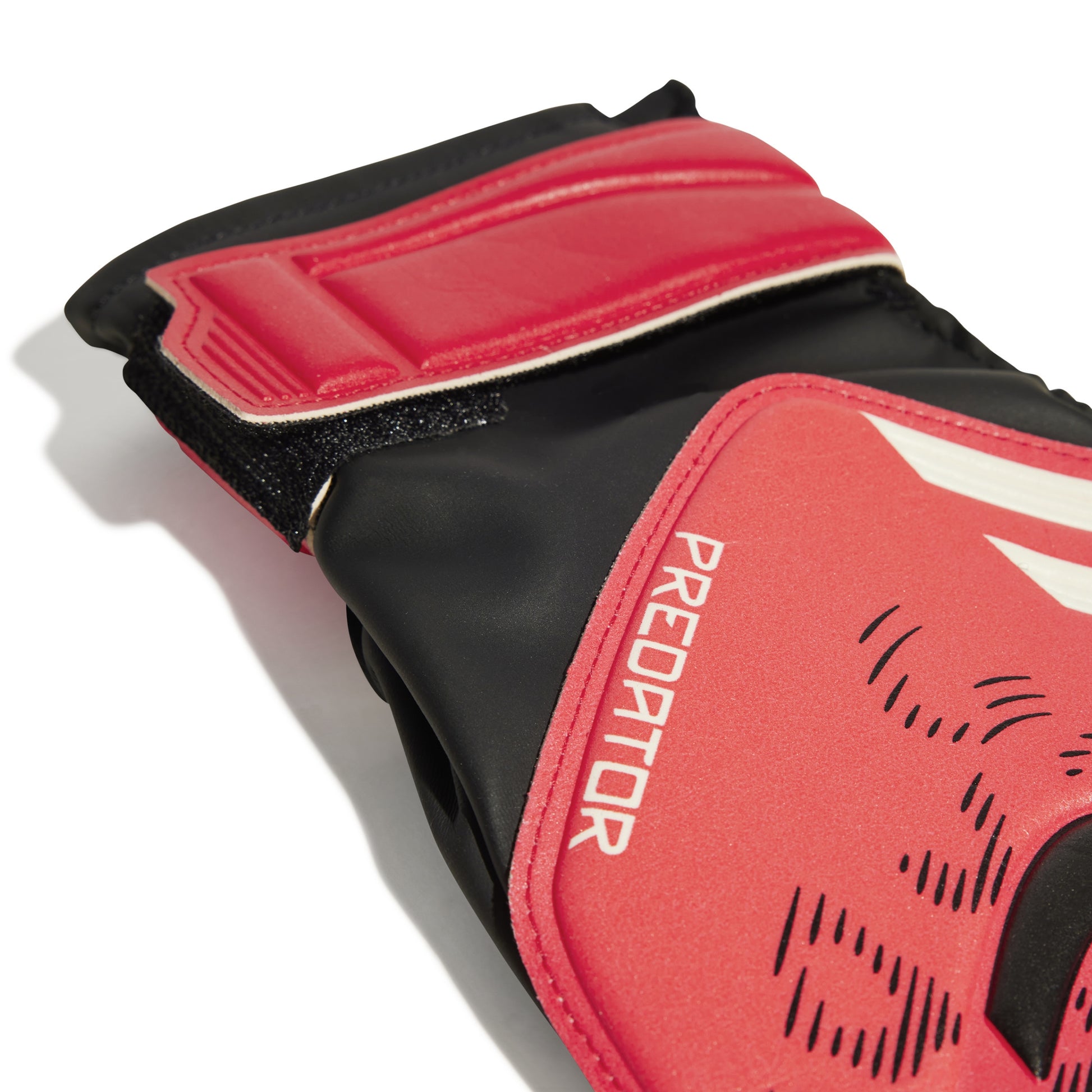 Red and black Adidas soccer goalkeeper glove with 'Predator' branding on a white background