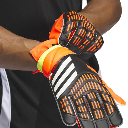 Close-up of orange and black soccer goalkeeper gloves with Adidas logo on a white background