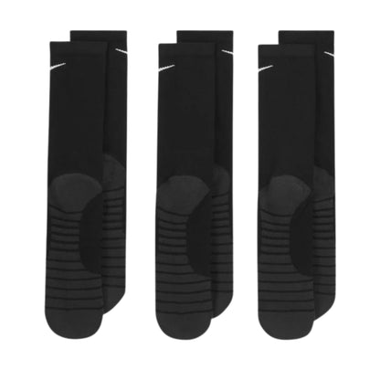 Three pairs of black socks with sole patterns on a white background