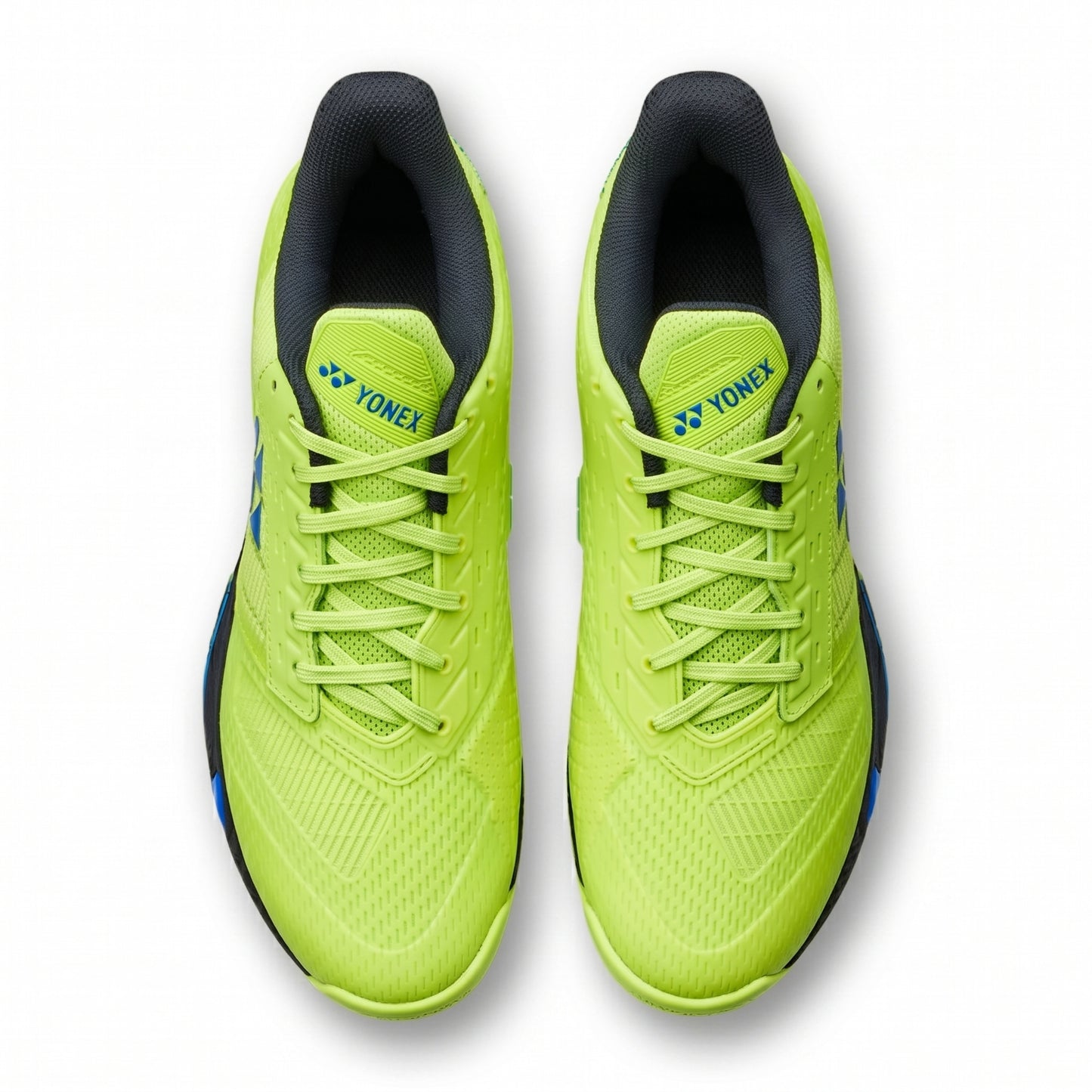 Pair of bright green running shoes with black soles on a white background