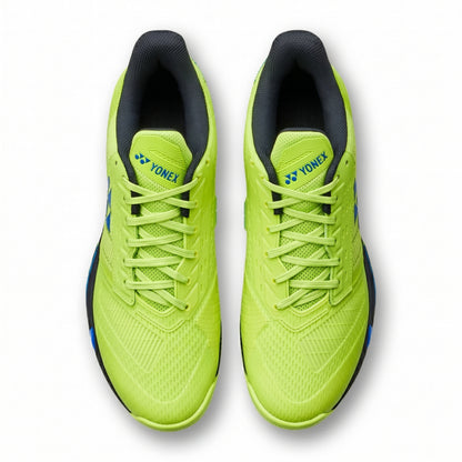 Pair of bright green running shoes with black soles on a white background