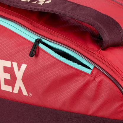 Red tennis bag with a visible brand logo on a red background