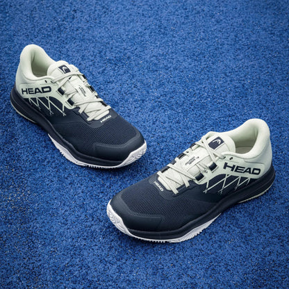 Pair of HEAD padel shoes on a blue textured surface