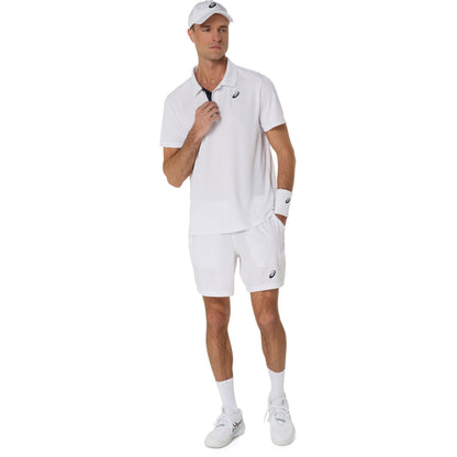 Man wearing a white tennis outfit with a logo on a white background