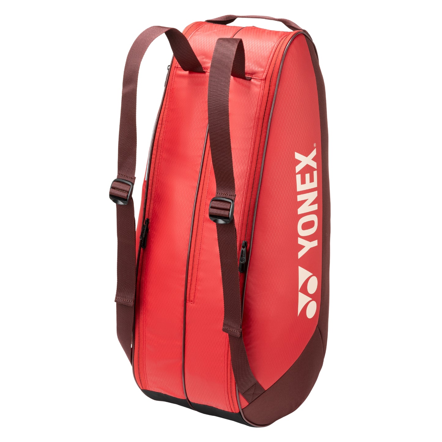 Red tennis bag with brown straps and Yonex logo on a white background