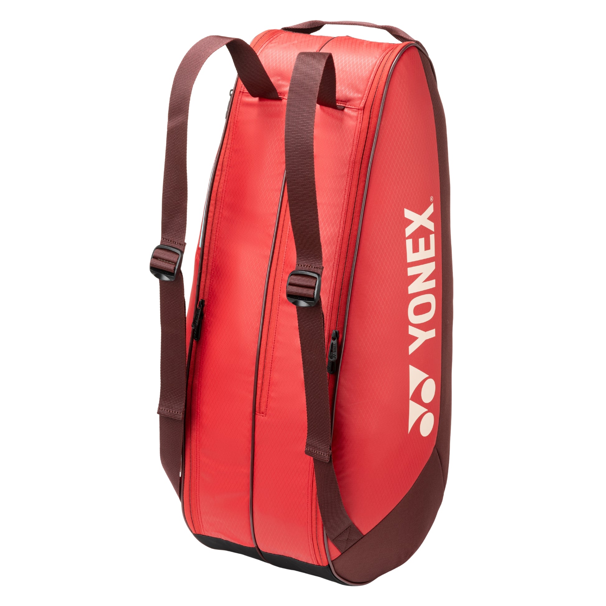 Red tennis bag with brown straps and Yonex logo on a white background