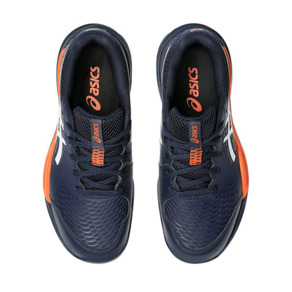 Navy and orange Asics tennis shoes on a white background