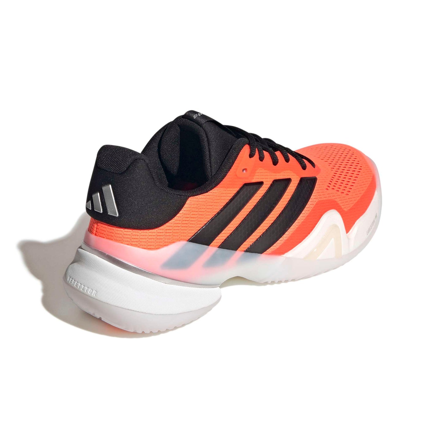 Orange and black Adidas tennis shoe on a white background