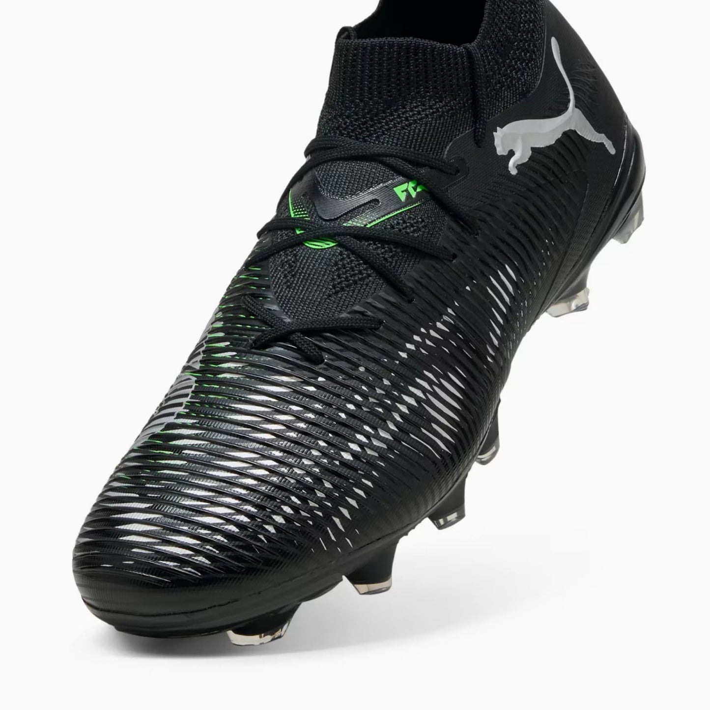 Black soccer Puma boot with Puma logo and green accents on a white background