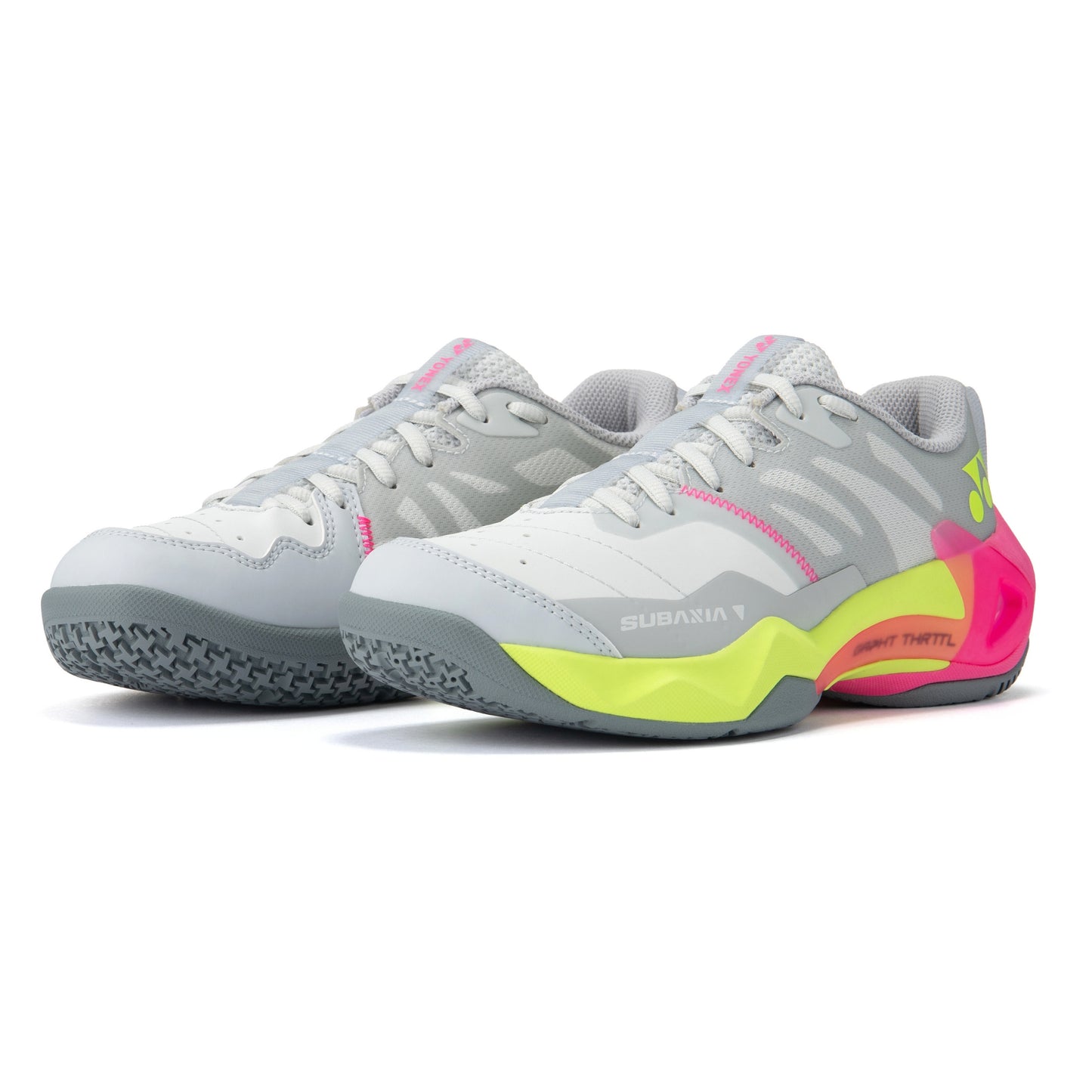 Pair of gray and pink Yonex shoes with green accents on a white background