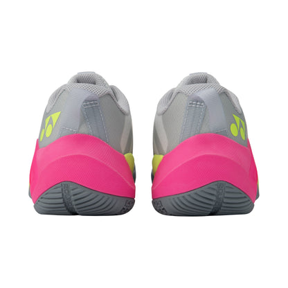Pair of gray and pink Yonex athletic shoes with a visible brand logo on a white background