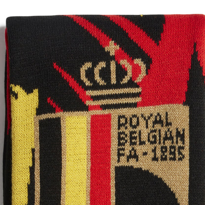 Close-up of a scarf with a logo and text, featuring red, black, yellow, and beige colors.