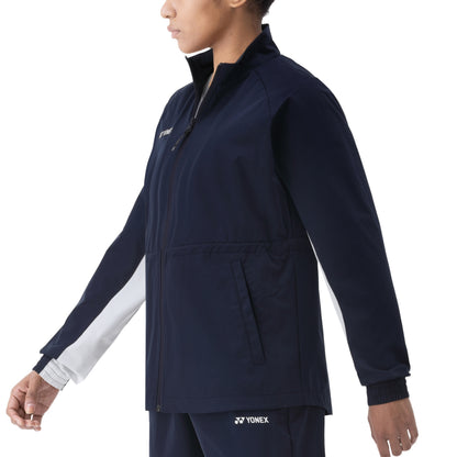 Person wearing a navy Yonex jacket on a white background