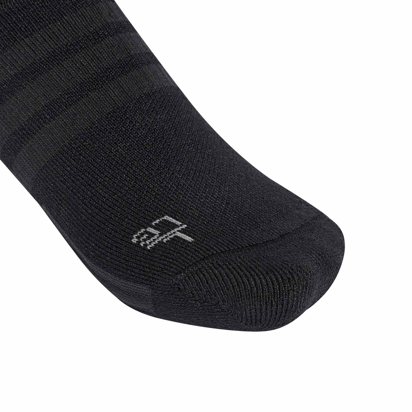 A close-up of a black athletic sock with subtle horizontal stripes and a small white logo on the toe, shown against a plain white background.
